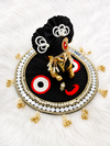 Close-up of black Laddu Gopal poshak with pearl and gold detailing