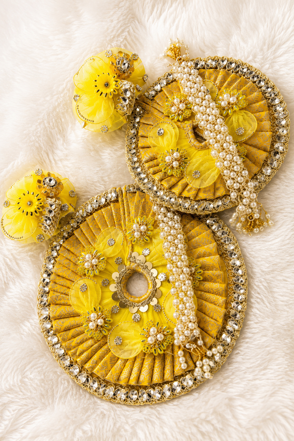 Yellow Laddu Gopal poshak with floral detailing and pearl embellishments