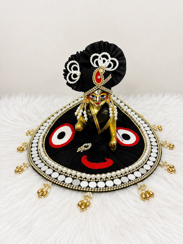 Black Laddu Gopal poshak with pearl detailing, red and white accents, and gold embellishments