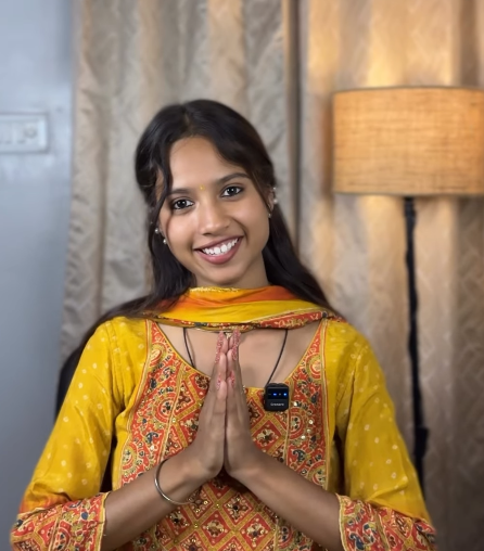 Woman wearing a yellow traditional Indian outfit with embroidered detailing